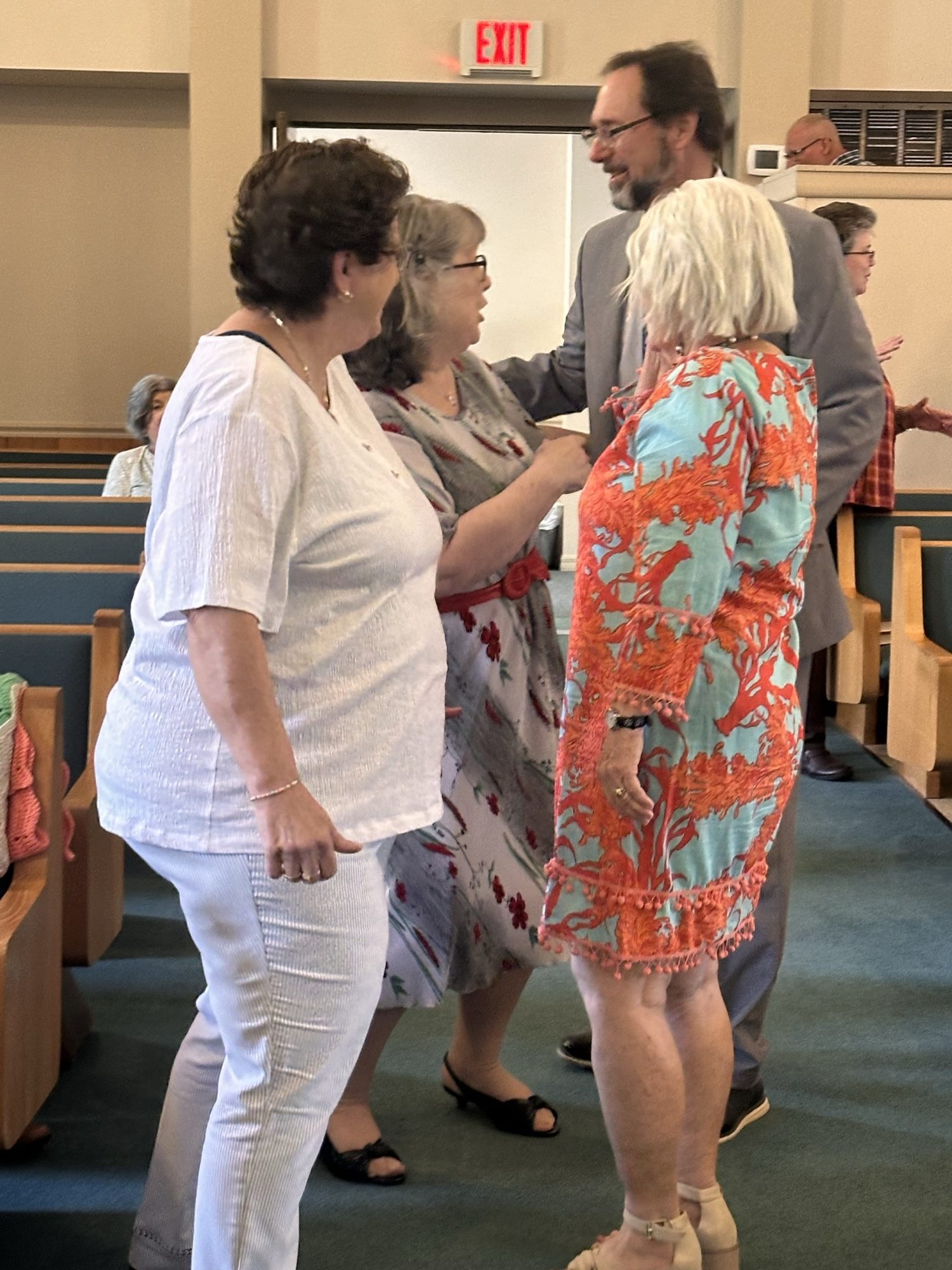 Women greeting one another at a women's ministry gathering